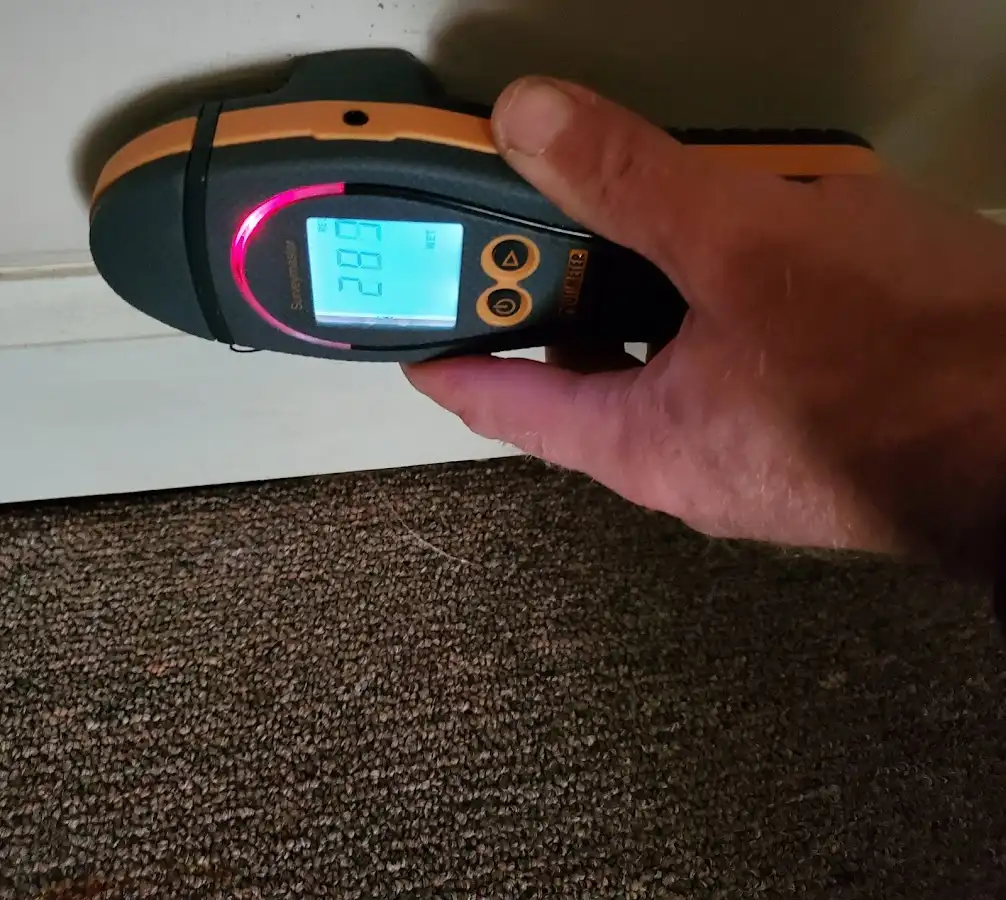 Moisture detection at baseboard during Storm Damage Restoration in Blackhawk